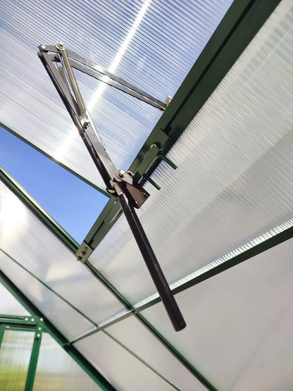 Automatic roof vent opener installed on greenhouse polycarbonate panel