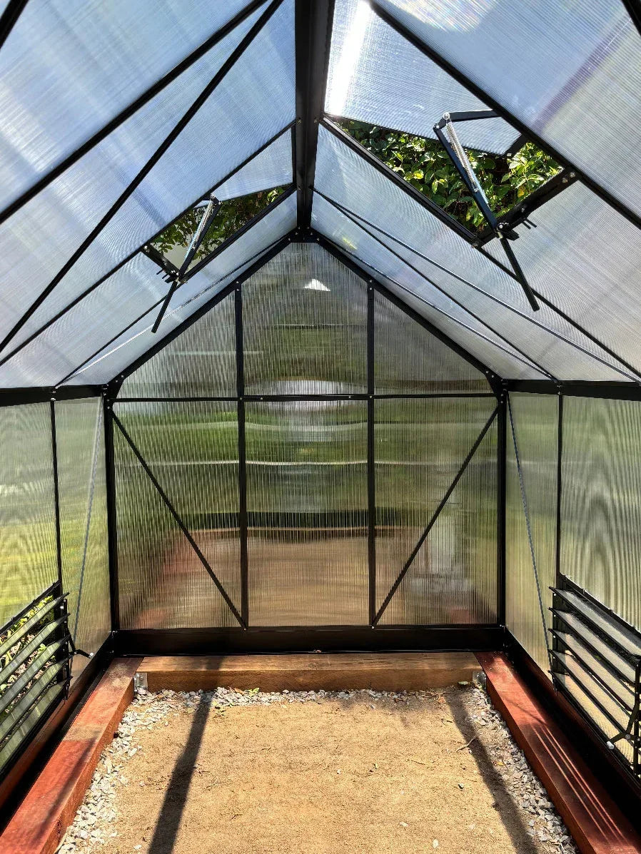 Interior of aluminium-frame greenhouse with UV-protected polycarbonate panels and vents