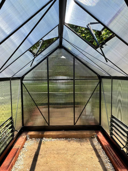 Interior of aluminium-frame greenhouse with UV-protected polycarbonate panels and vents
