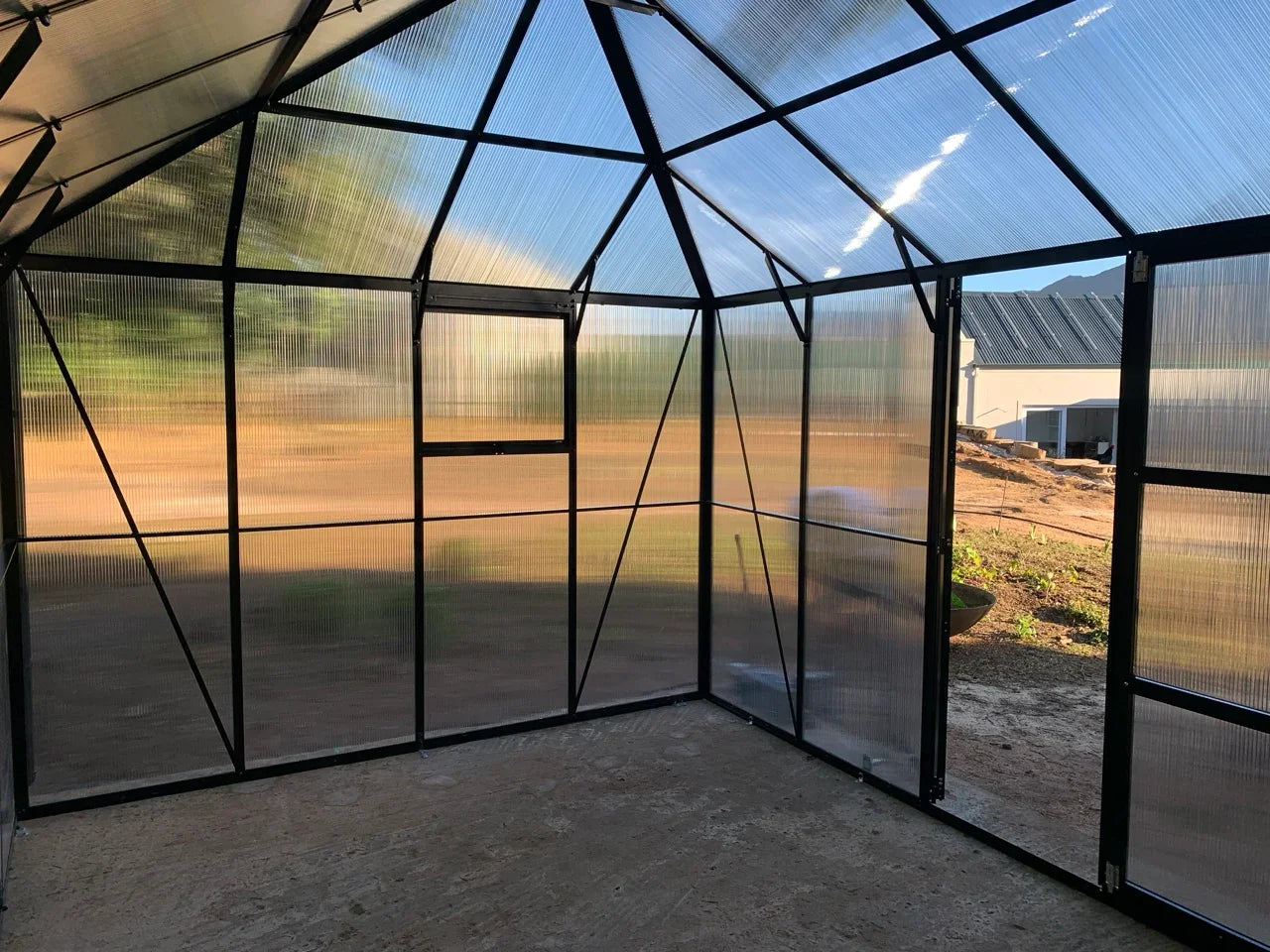Interior of a geometrically designed greenhouse with polycarbonate panels.